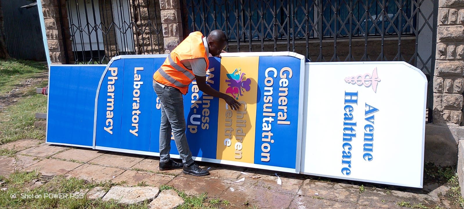 Bright Signage Hub Kenya team installing wayfinding signage for Avenue Healthcare