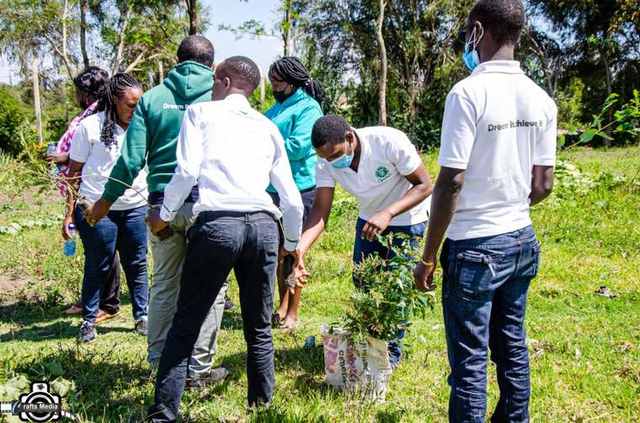 Bright Signage Hub volunteers joining a community tree-planting drive with local youth